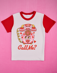 White body with mustang red sleeves and neckline. Illustration of a pink vintage phone with red hearts in the center. Phone has a face with red lips. Call Me? text below in red.