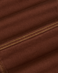 Carpenter Jeans in Fudgesicle Brown fabric detail close up with yellow contrast stitching