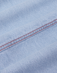 Carpenter Jeans in Light Wash fabric detail close up with red contrast stitching