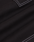Carpenter Shorts in Basic Black fabric detail close up.Contrast white stitching.