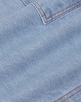 Carpenter Shorts in Light Wash fabric detail close up. Contrast orange stitching.