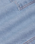 Carpenter Shorts in Light Wash fabric detail close up. Contrast orange stitching.