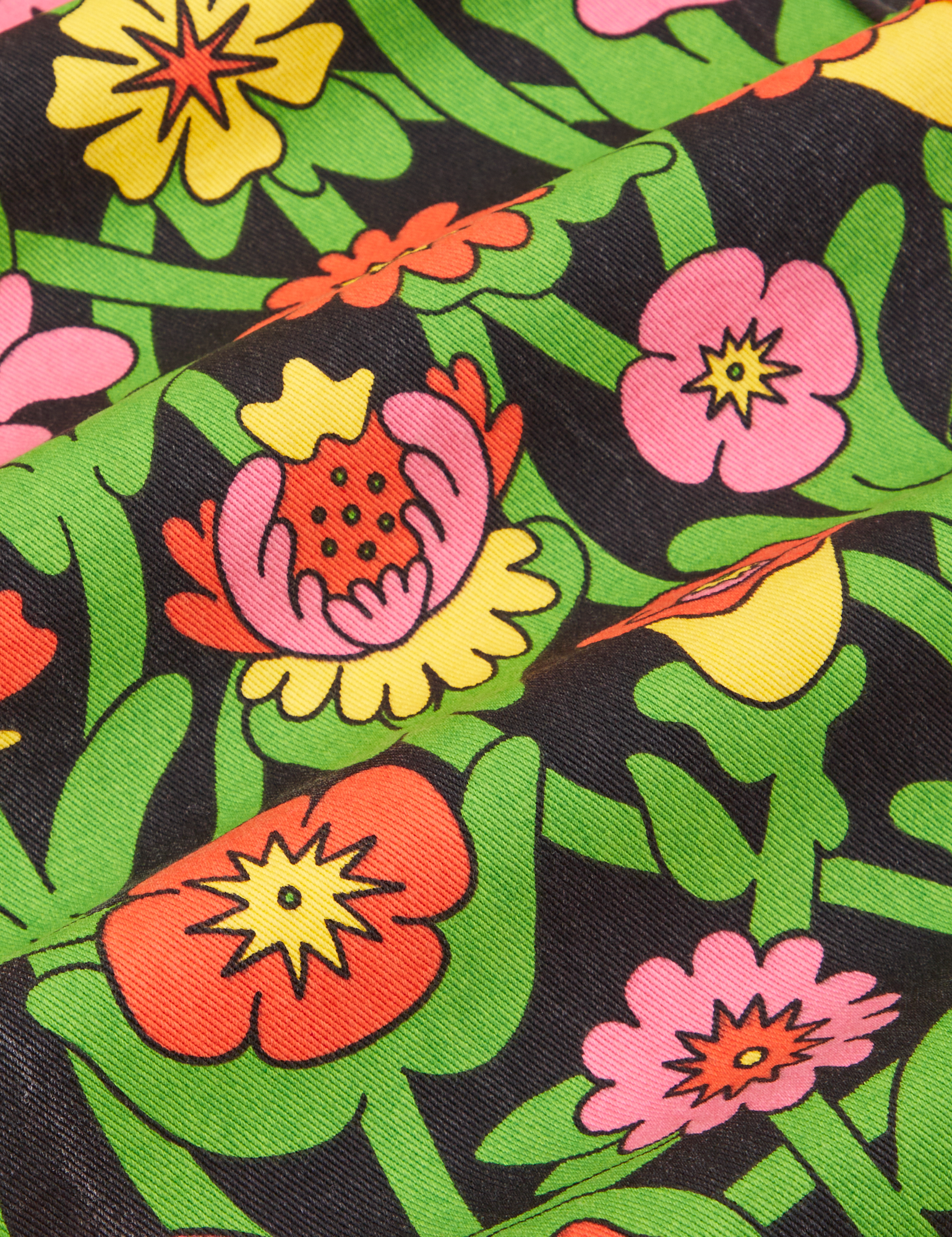 Work Pants in Flower Tangle fabric detail close up. Green vines with red and pink flowers.
