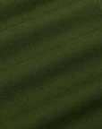 Baggy Mid-Rise Trousers in Evergreen fabric detail close up