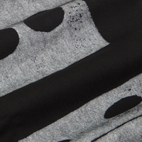 Fabric detail close up of Icon Work Pants in Dice. Large white dice paintstamped onto black Work Pants.