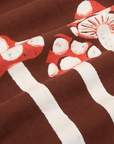 Paintstamped Work Pants in Mushroom fabric detail close up. Red and white mushrooms