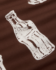 Soda Bottle Pantry Button-Up in Fudgesicle Brown close up of white paintstamped bottle