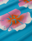 Paintstamped Pantry Button-Up in Hawaiian Blue fabric detail close up. White, pink and orange paintstamped fflowers.