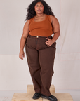 Morgan is wearing Overdyed Denim Trouser in Fudge and burnt terracotta Cropped Tank