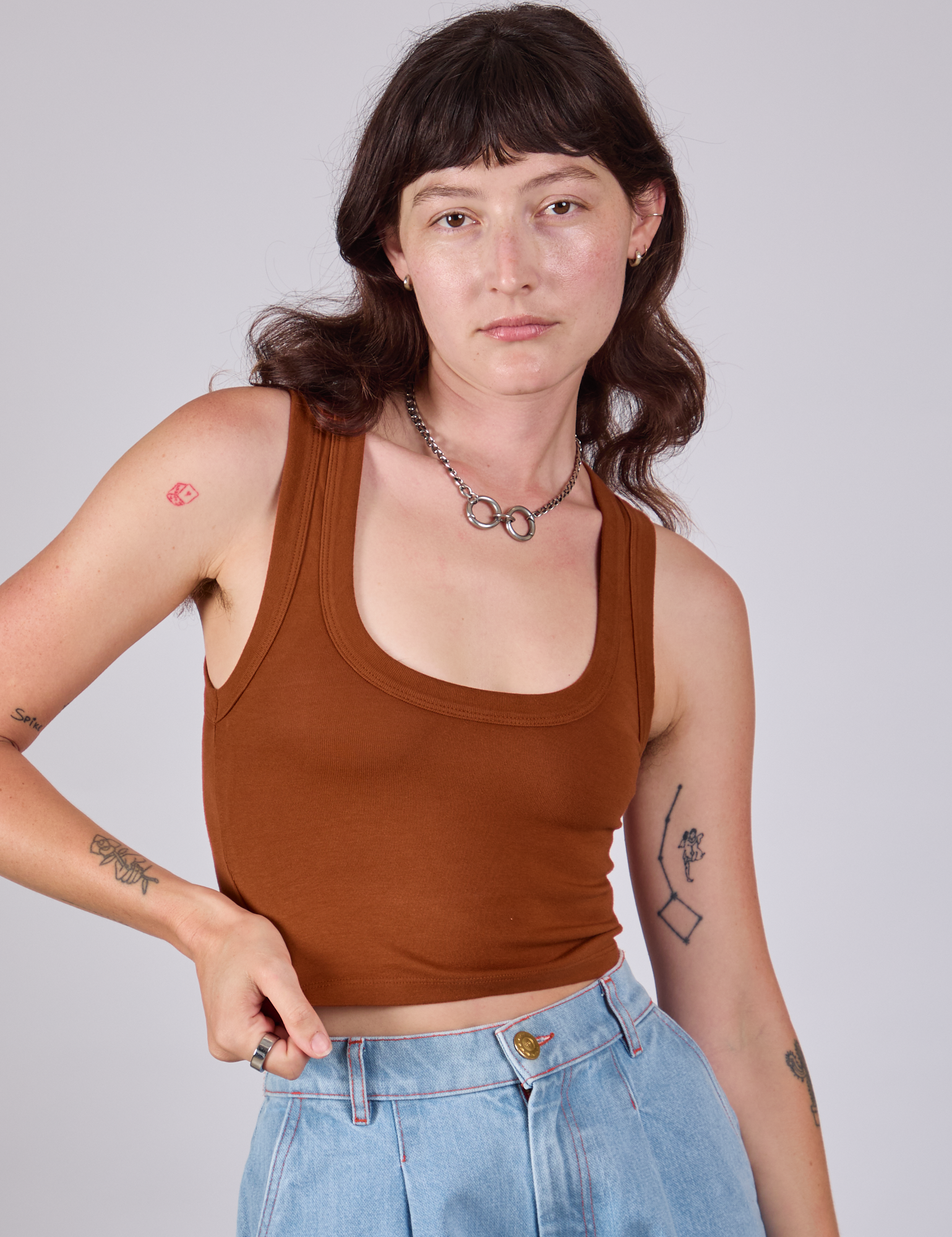 Alex is wearing Cropped Tank Top in Burnt Terracotta
