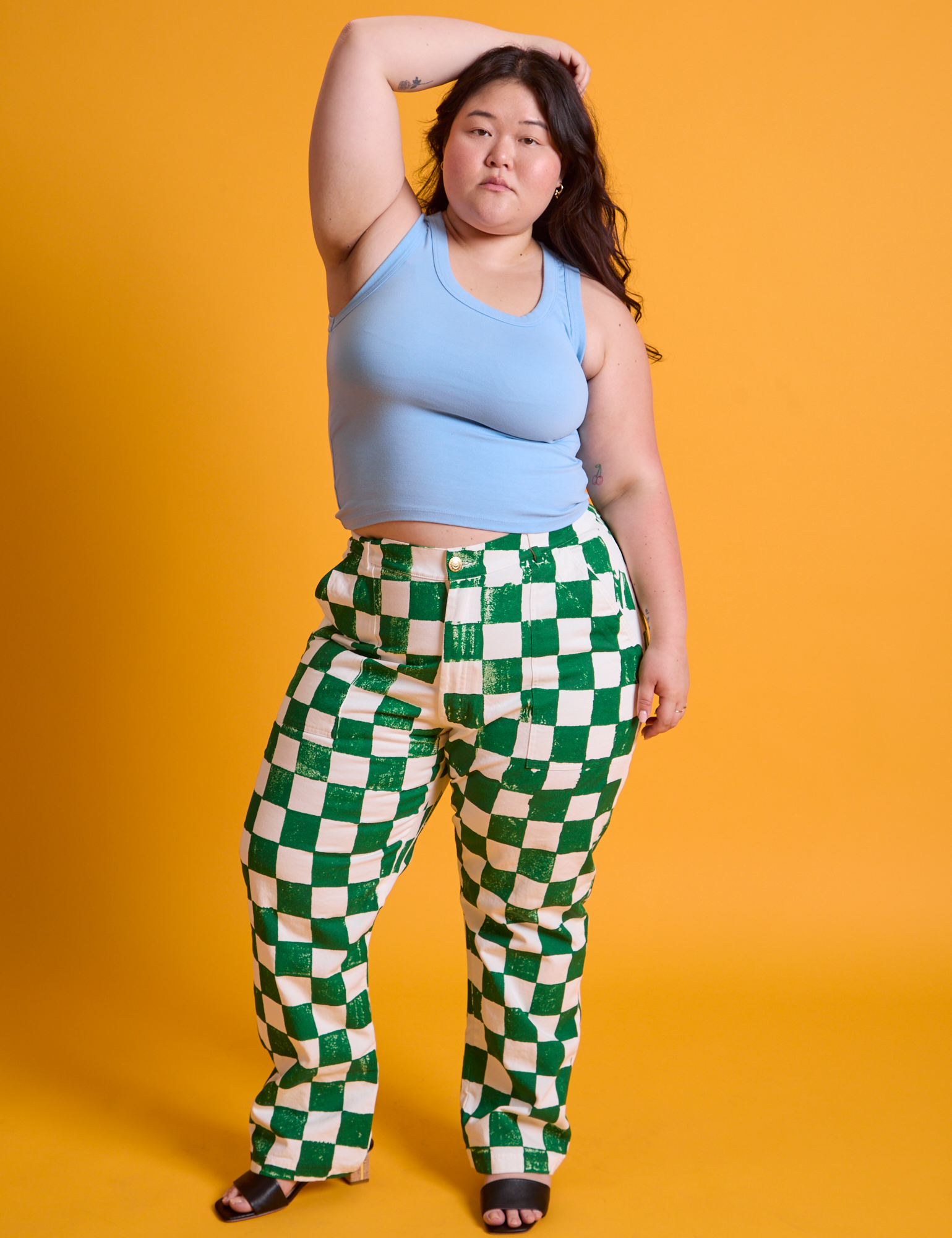 Ashley is wearing Checkerboard Work Pants in White/Green and baby blue Tank Top