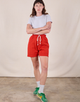 Alex is wearing Sweat Shorts in Mustang Red