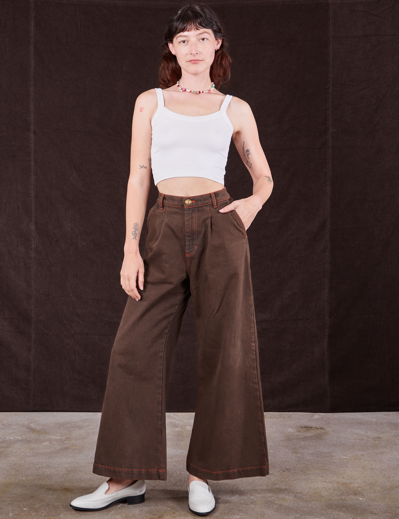 Alex is 5&#39;8&quot; and wearing XXS Overdyed Wide Leg Trousers in Brown paired with Cropped Cami in vintage tee off-white