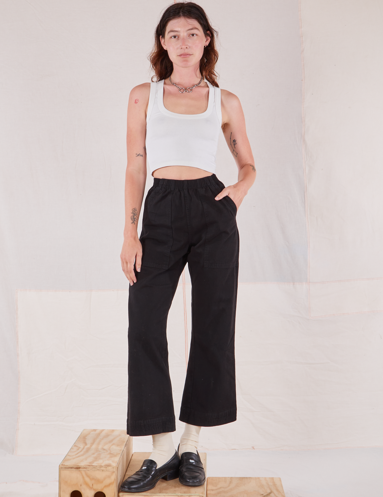 Alex is 5'8" and wearing P Action Pants in Basic Black paired with Cropped Tank in vintage tee off-white