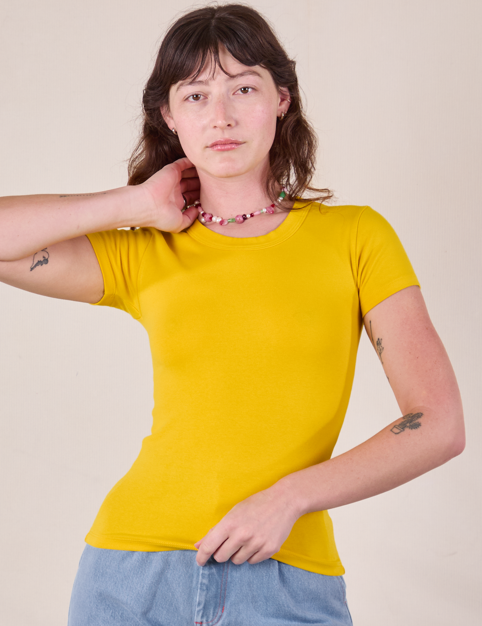 Alex is 5'8 and wearing P Baby Tee in Golden Yellow