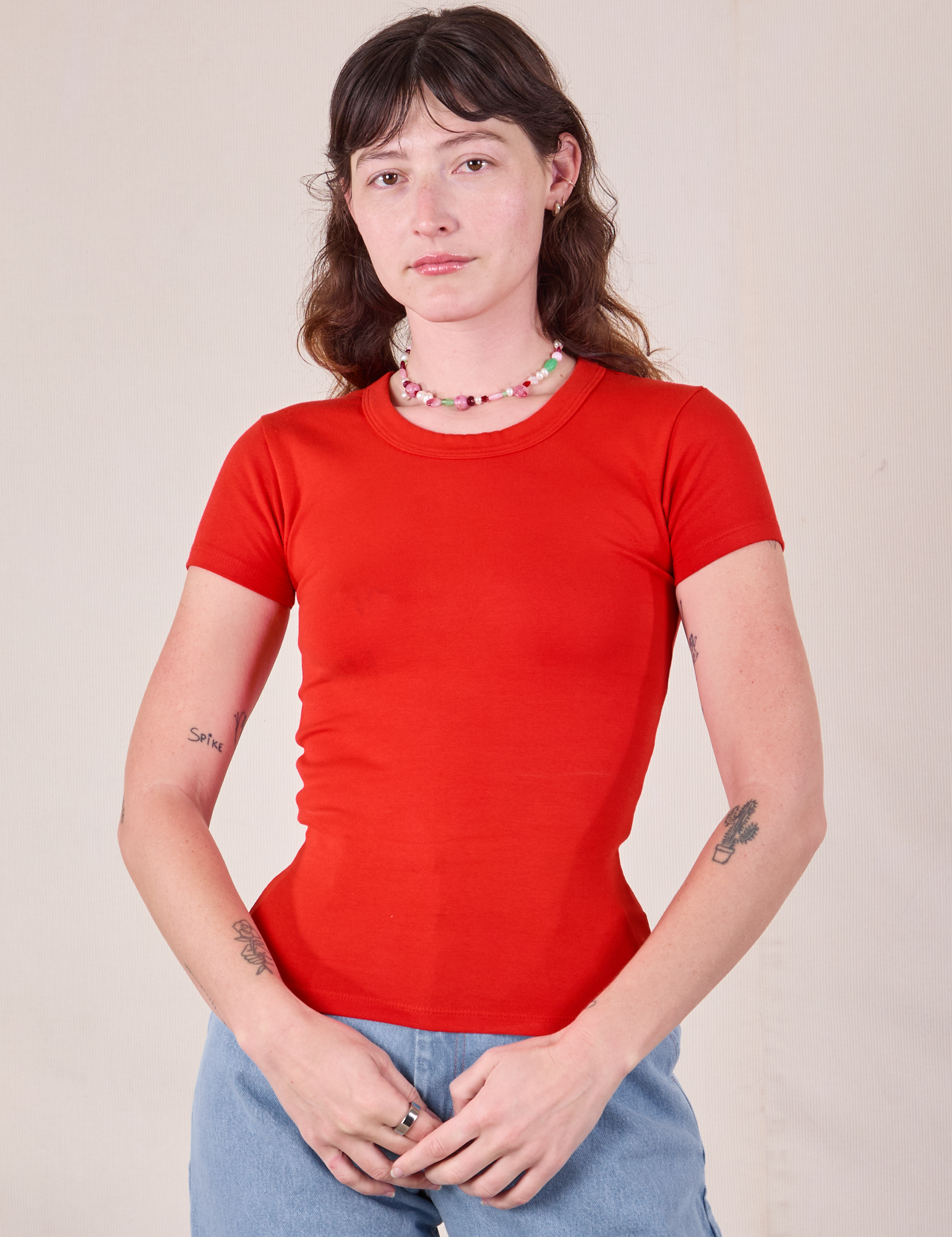 Alex is 5'8 and wearing P Baby Tee in Mustang Red