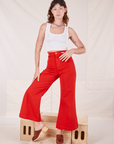 Alex is 5'8" and wearing XXS Bell Bottoms in Mustang Red paired with Cropped Tank Top in vintage tee off-white