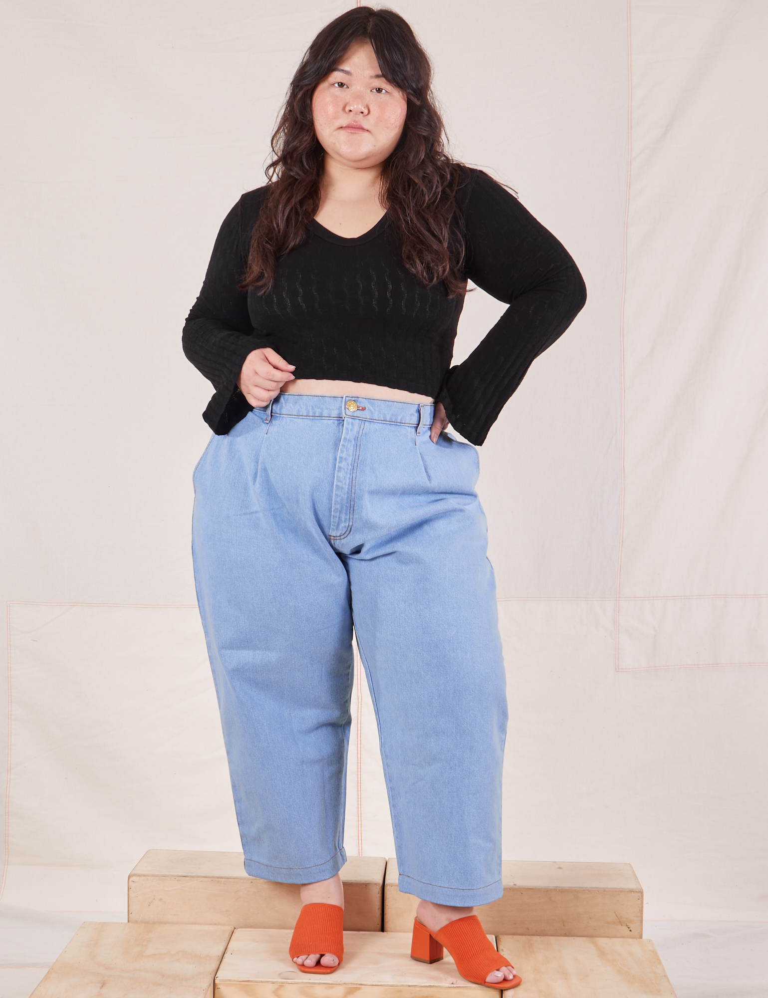 Ashley is wearing Bell Sleeve Top in Basic Black and light wash Trouser Jeans
