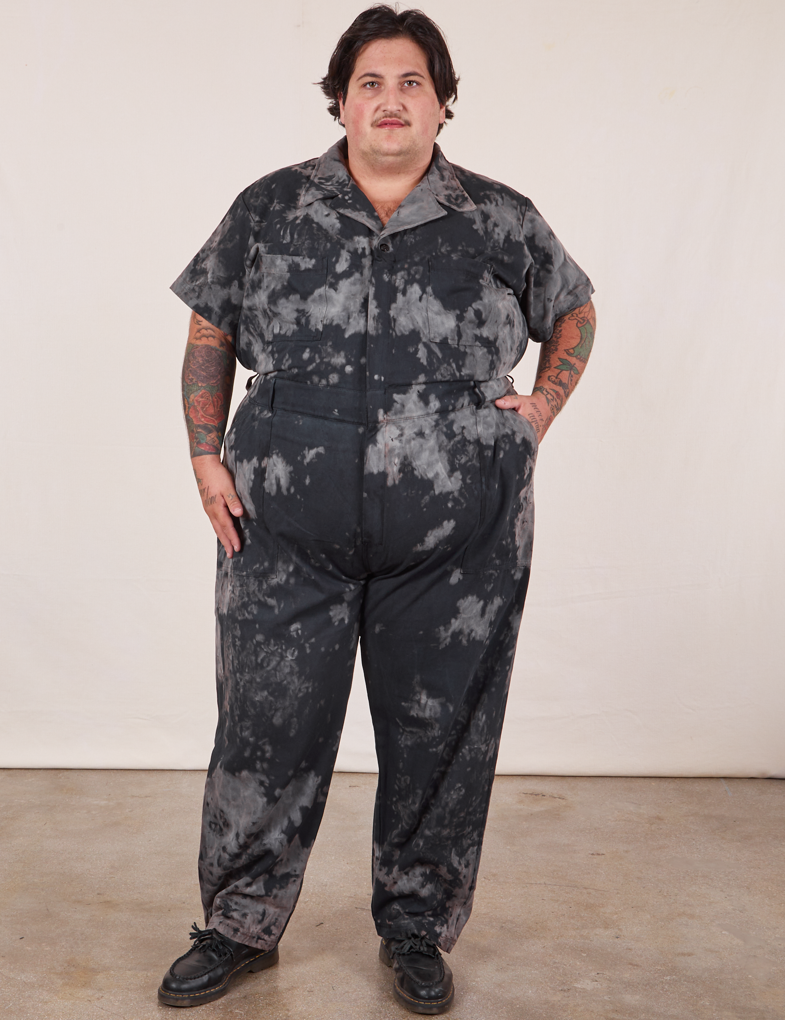 Sam is 5'10" and wearing 3XL Short Sleeve Jumpsuit in Black Magic Waters