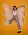 Alex is wearing Butterfly Kaleidoscope Work Pants and vintage tee white Cropped Tank