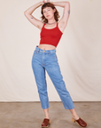 Alex is 5'8" and wearing P Cropped Cami in Mustang Red paired with light wash Frontier Jeans