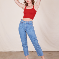 Alex is 5'8" and wearing P Cropped Cami in Mustang Red paired with light wash Frontier Jeans