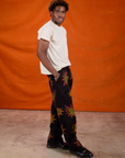Side view of Paintstamped Work Pants in Explosion and Organic Vintage Tee in Vintage Off-White