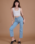 Alex is wearing Carpenter Jeans in Light Wash and Cropped Tank in Vintage Tee Off-White