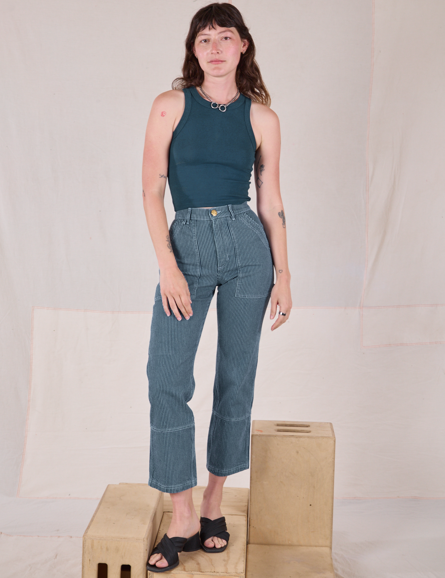 Alex is 5’8” and wearing XXS Railroad Carpenter Jeans in Baby Blue paired with marine blue Muscle Tee