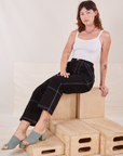 Alex is wearing Carpenter Jeans in Black and Cropped Cami in vintage tee off-white