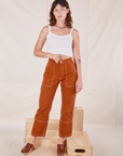 Alex is 5'8" and wearing XXS Carpenter Jeans in Burnt Terracotta paired with Cropped Cami in vintage tee off-white