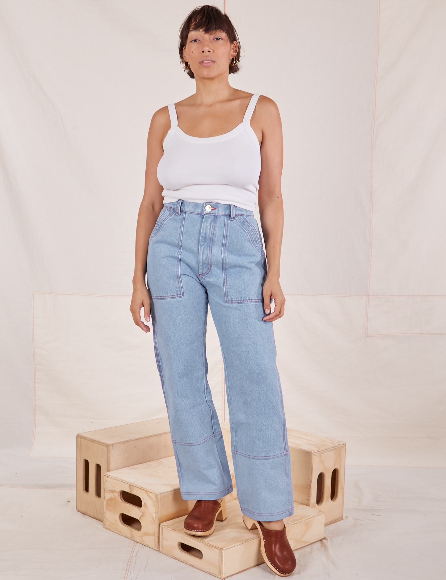 Tiara is wearing Carpenter Jeans in Light Wash and Cropped Cami in vintage tee off-white