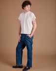 Angled front view of Carpenter Jeans in Dark Wash and Organic Vintage Tee in Vintage Tee Off-White on Quinn