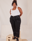 Morgan is wearing Carpenter Jeans in Black and Tank Top in vintage tee off-white