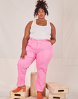 Morgan is wearing Carpenter Jeans in Bubblegum Pink and Tank Top in vintage tee off-white