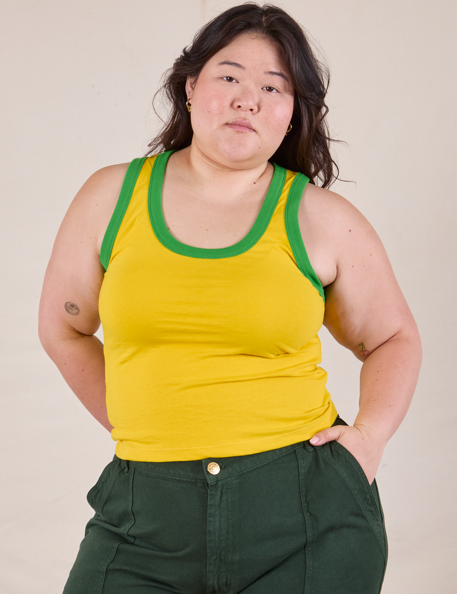 Ashley is 5'7" and wearing L Colorblock Cropped Tank in Golden Yellow