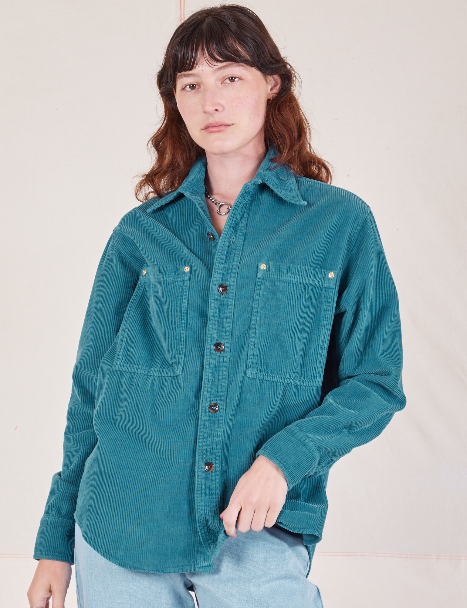 Alex is 5'8" and wearing P a buttoned up Corduroy Overshirt in Marine Blue
