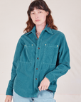 Alex is 5'8" and wearing P a buttoned up Corduroy Overshirt in Marine Blue