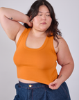 Ashley is 5'7" and wearing L Cropped Tank Top in Creamsicle Orange