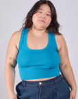 Ashley is 5'7" and wearing L Cropped Tank Top in Hawaiian Blue