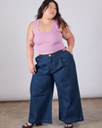 Ashley is wearing Cropped Tank Top in Lilac and dark wash Indigo Wide Leg Trousers