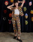 Alex is wearing Halloween Masks Pantry Button-Up paired with matching Work Pants
