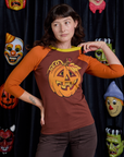 Alex is 5'8" and wearing P Raglan Tee in Jack-O-Lantern
