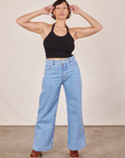 Tiara is wearing Halter Top in Basic Black and light wash Sailor Jeans