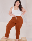 Ashley is 5'7" and wearing L Rolled Cuff Sweat Pants in Burnt Terracotta paired with Cropped Tank in vintage tee off-white 