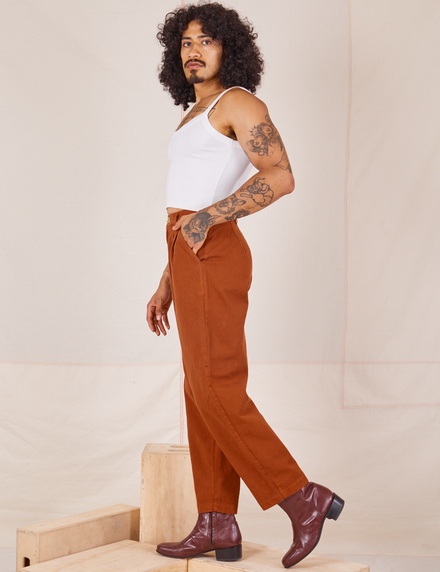 Side view of Heavyweight Trousers in Burnt Terracotta and Cropped Cami in vintage tee off-white worn by Jesse