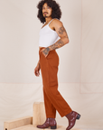 Side view of Heavyweight Trousers in Burnt Terracotta and Cropped Cami in vintage tee off-white worn by Jesse