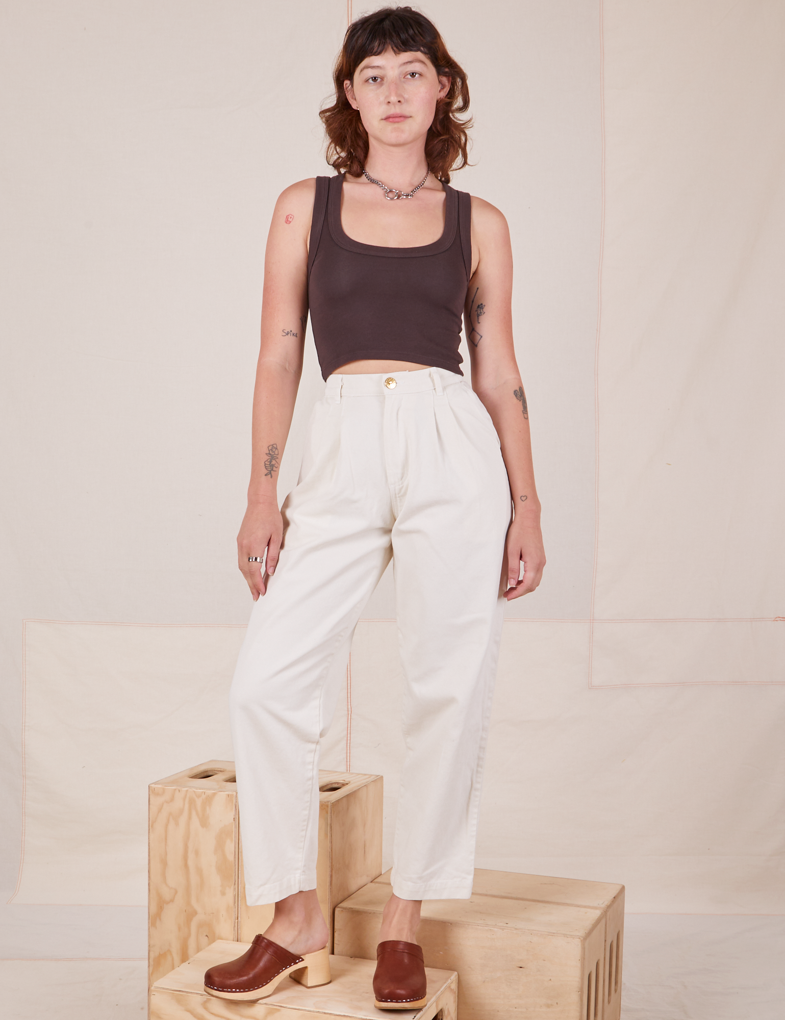 Alex is wearing Heavyweight Trousers in Vintage Tee Off-White and espresso brown Cropped Tank Top.