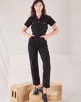 Alex is 5'8" and wearing XXS Heritage Short Sleeve Jumpsuit in Basic Black