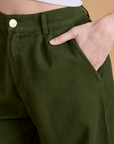 Close up of Alex's hand in the front pocket of Heritage Wide Leg Trousers in Evergreen
